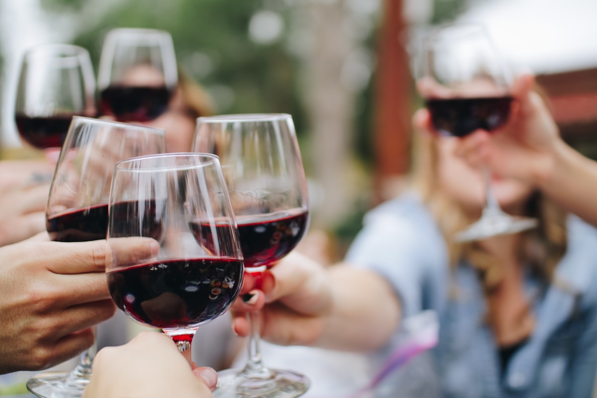 A glass of wine on a wooden table, soft afternoon light